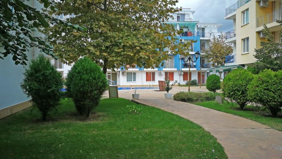 Bright outdoor view of Sunny Day 3 residential buildings near Sunny Beach, featuring lush greenery a.