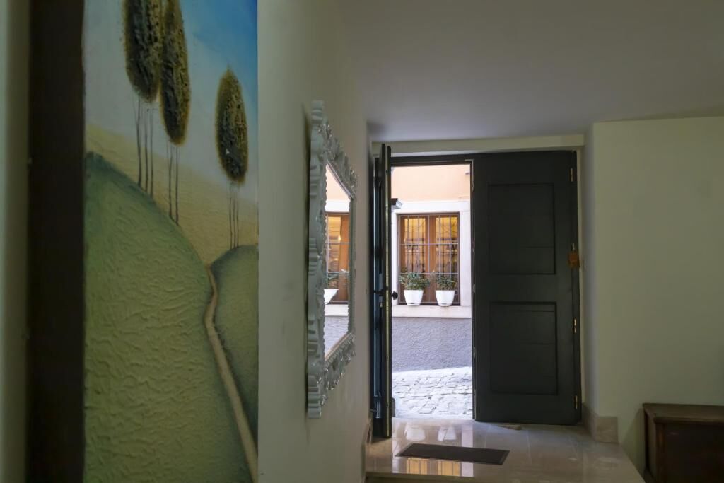 House for Sale in Sepino Italy | Homesgofast House entrance with open door in Sepino, Italy, showcasing a cozy interior and outdoor patio.