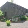 Vineyard with villa plans for sale in Trecastagni, Sicily, featuring rustic stone walls and lush sur.