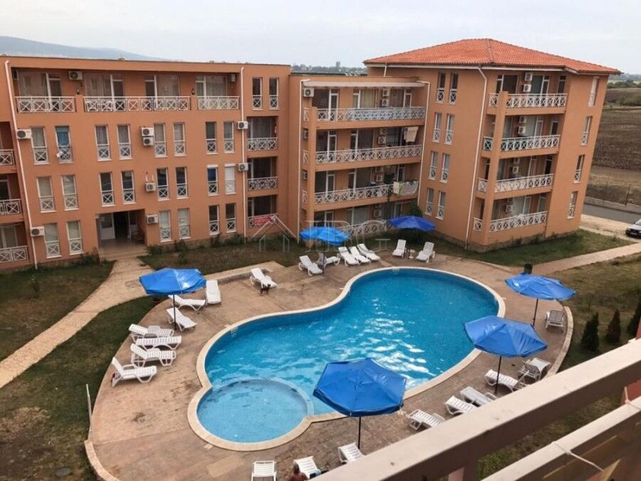 Apartment complex with a pool, sun loungers, and umbrellas in Sunny Day 6, Sunny Beach.