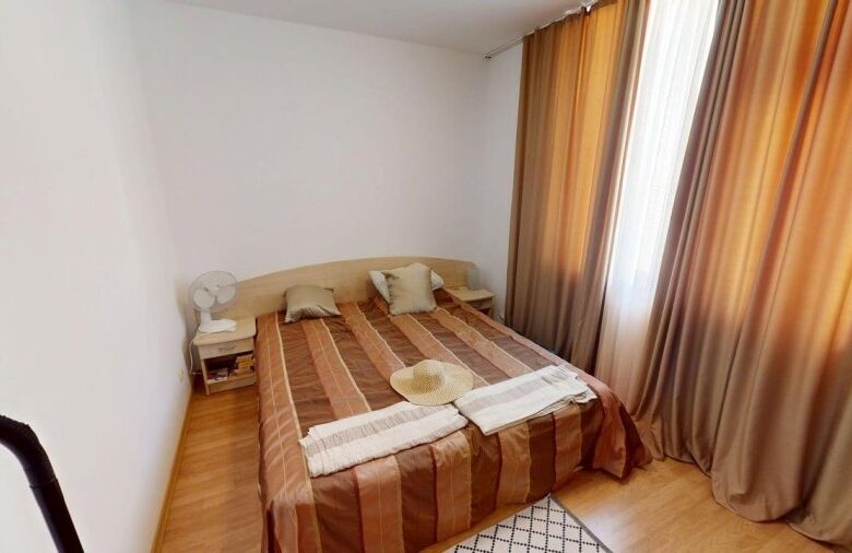 Bright 2-bedroom apartment with large windows and curtains in Sunny Beach, Bulgaria.