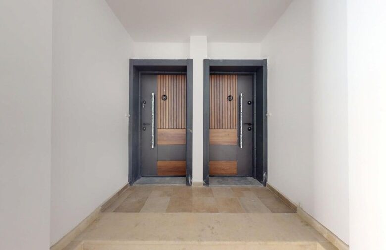 Entrance doors of a ground floor apartment in Grand Village, near the sea.