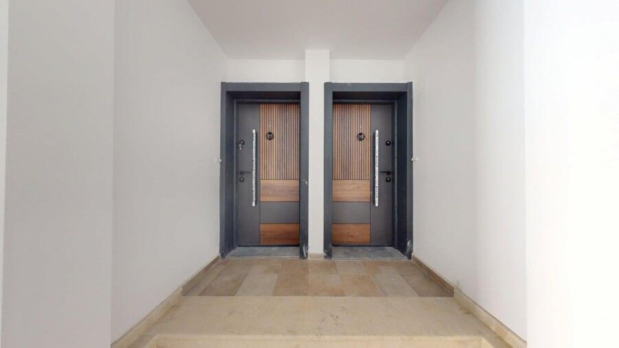 Entrance doors of a ground floor apartment in Grand Village, near the sea.