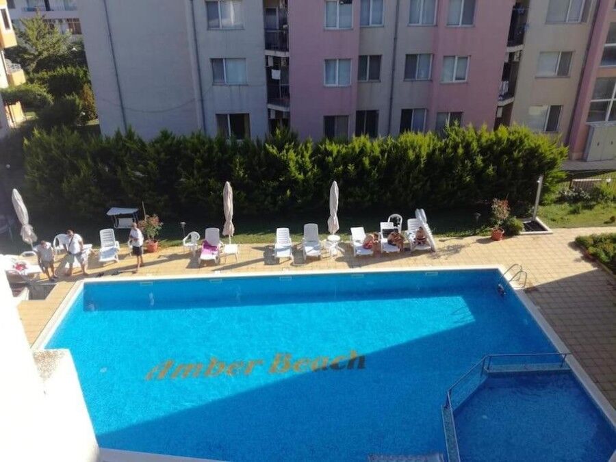 Maisonette for sale in Amber Beach, Sunny Beach Amber Beach pool with sun loungers and umbrellas in Sunny Beach resort.