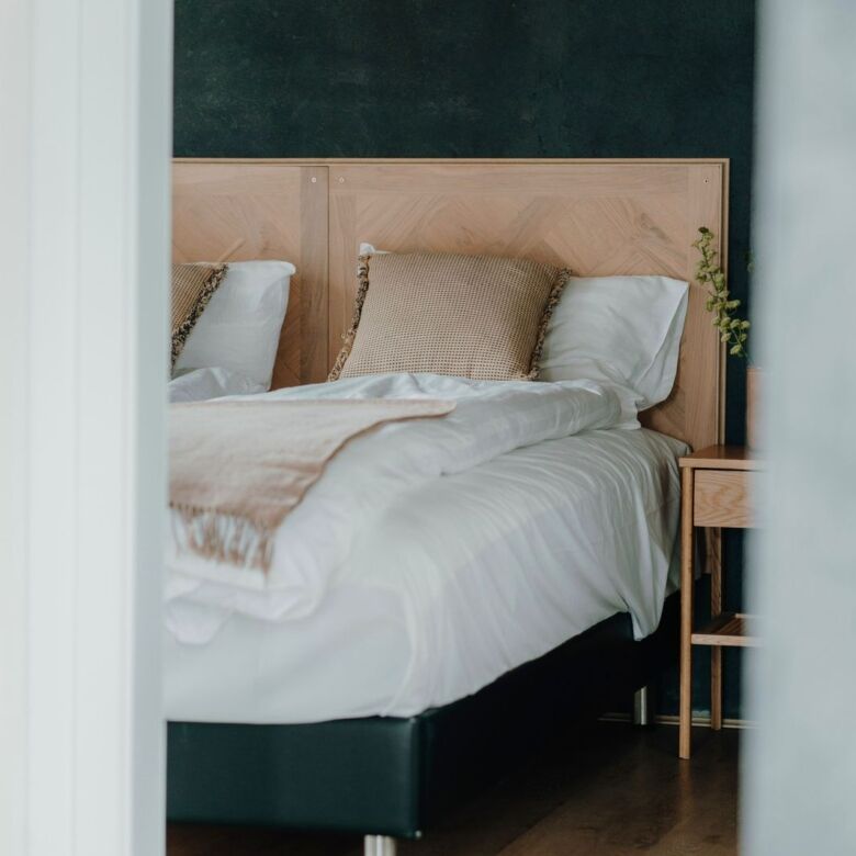 Luxury geothermal designer villa bedroom in Reykjavik with modern decor and high-end finishes.