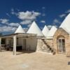 Elegant Trulli villa for sale in Ostuni, Puglia, featuring classic stone architecture and modern ame.