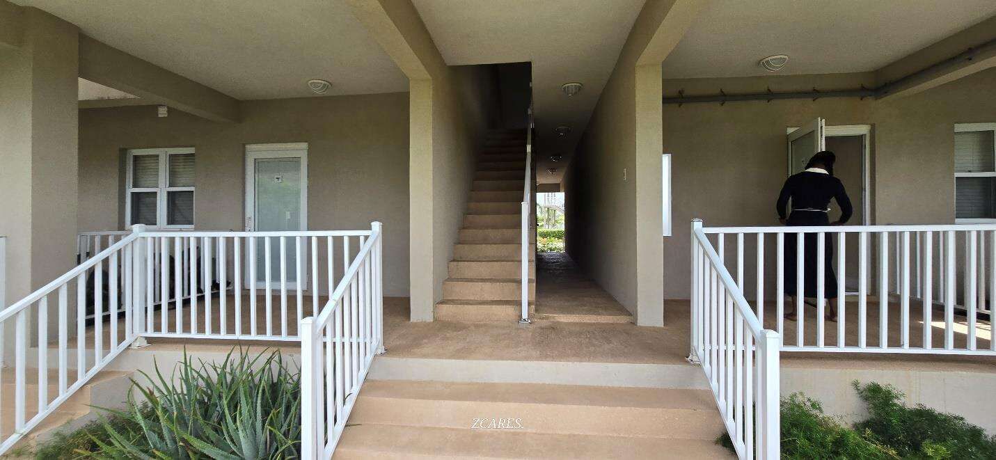 Interior view of a 1-bedroom villa at Imperial Bay Residences with stairs and balcony.