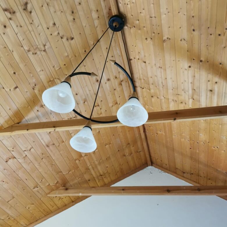 Charming wooden ceiling with modern chandelier in a beautiful home in Cloonagh, County Sligo.