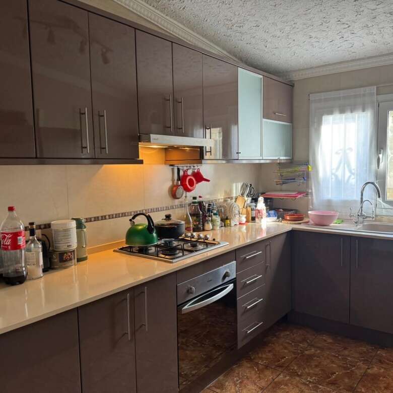 Bright, well-equipped kitchen with ample storage and natural light.