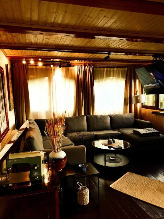 Cozy living room in a spacious 4-bedroom house in Chiriteni with wooden accents and warm lighting.