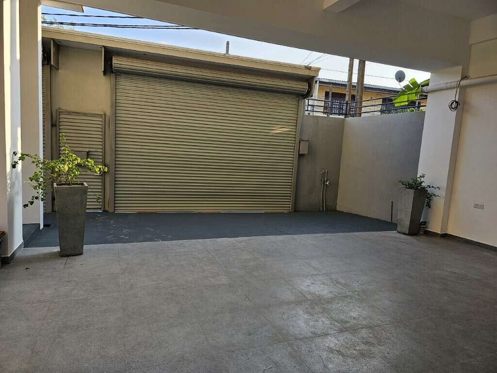 Spacious garage area in a luxury 12-bedroom condo building in Colombo, Sri Lanka. Modern design with.