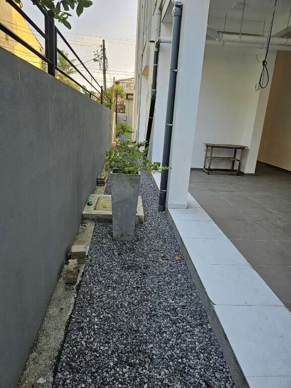 Modern outdoor corridor with potted plants in Colombo, Sri Lanka.