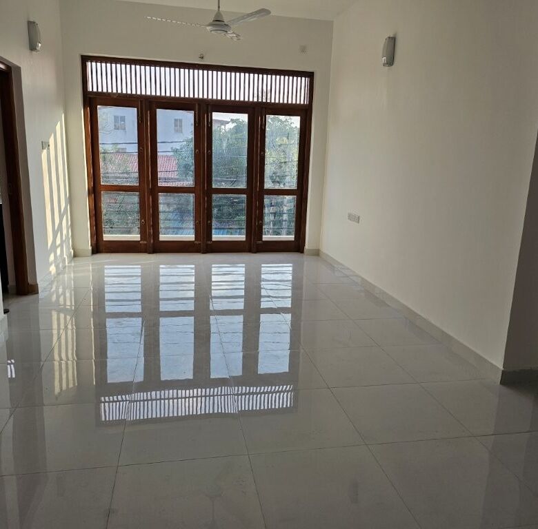 Spacious 12-bedroom luxury condo in Colombo featuring large windows and balcony, ideal for upscale l.