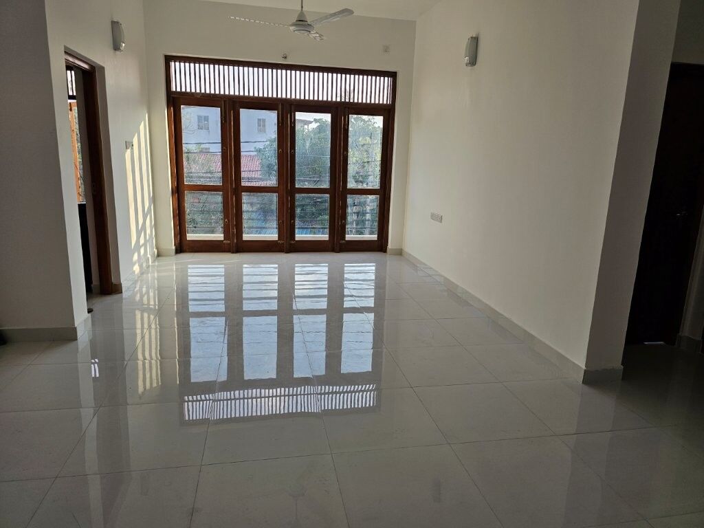 Spacious 12-bedroom luxury condo in Colombo featuring large windows and balcony, ideal for upscale l.