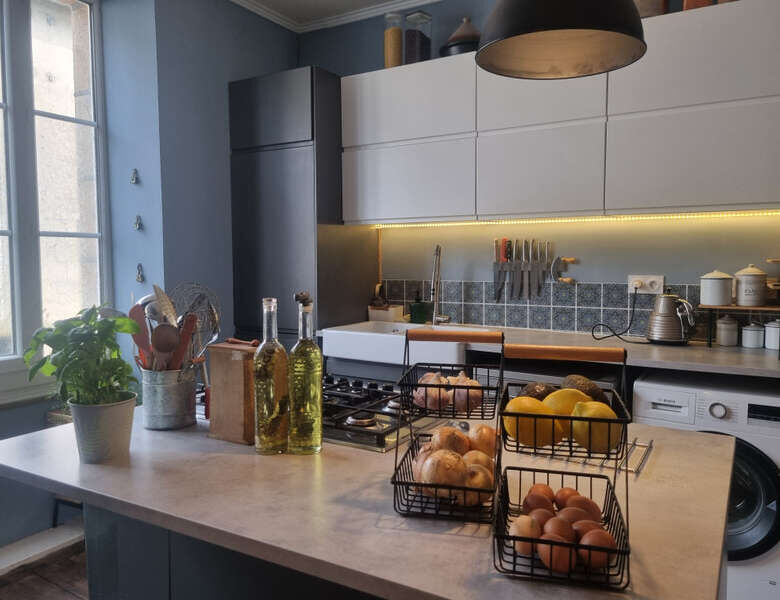 Elegant kitchen in a stone mansion for sale in Bugeat, featuring modern appliances and stylish decor.