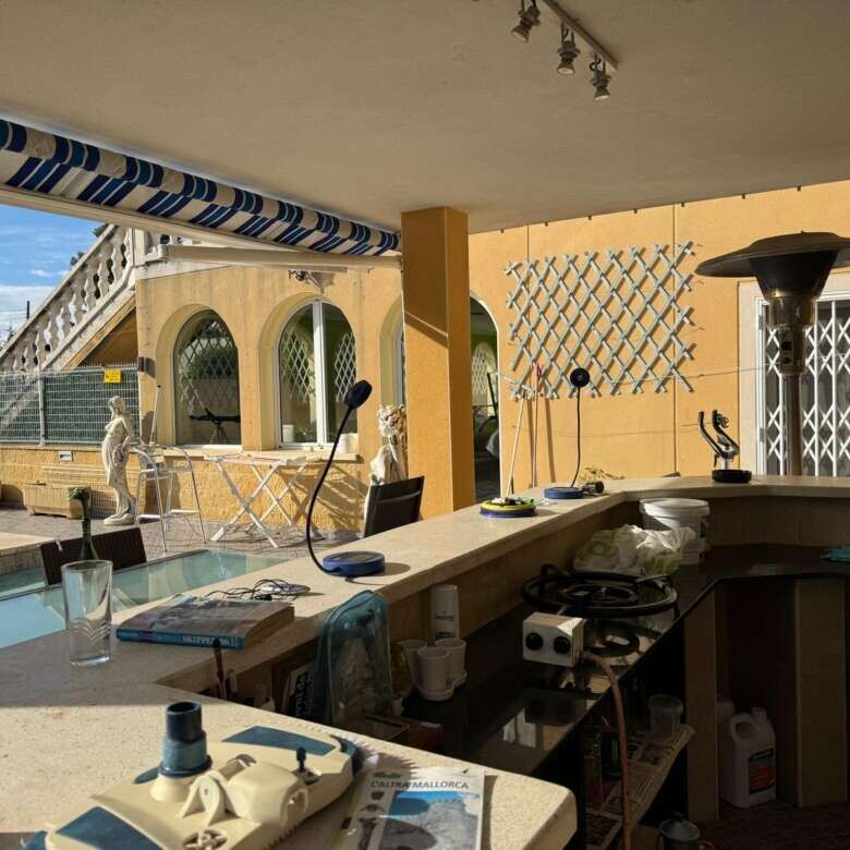 Outdoor view of a stylish villa with pool, seating area, and scenic surroundings in Tarragona.