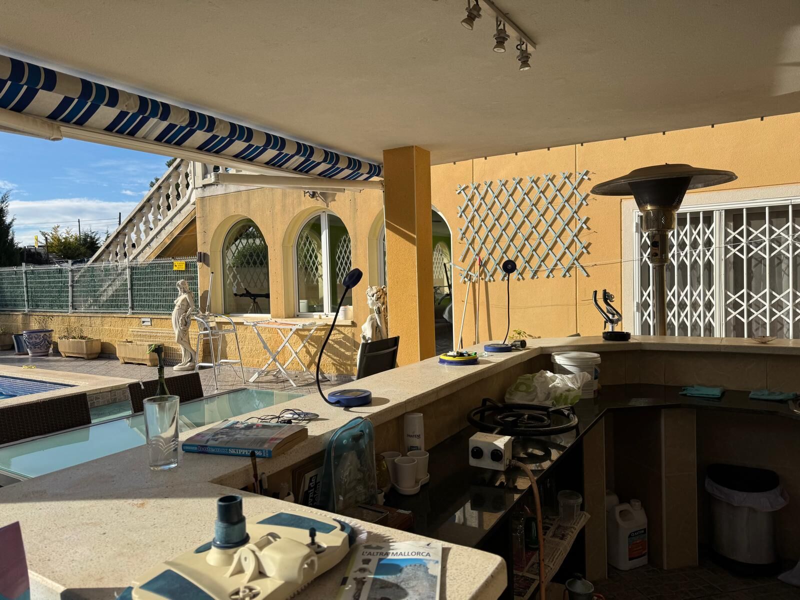 Outdoor view of a stylish villa with pool, seating area, and scenic surroundings in Tarragona.