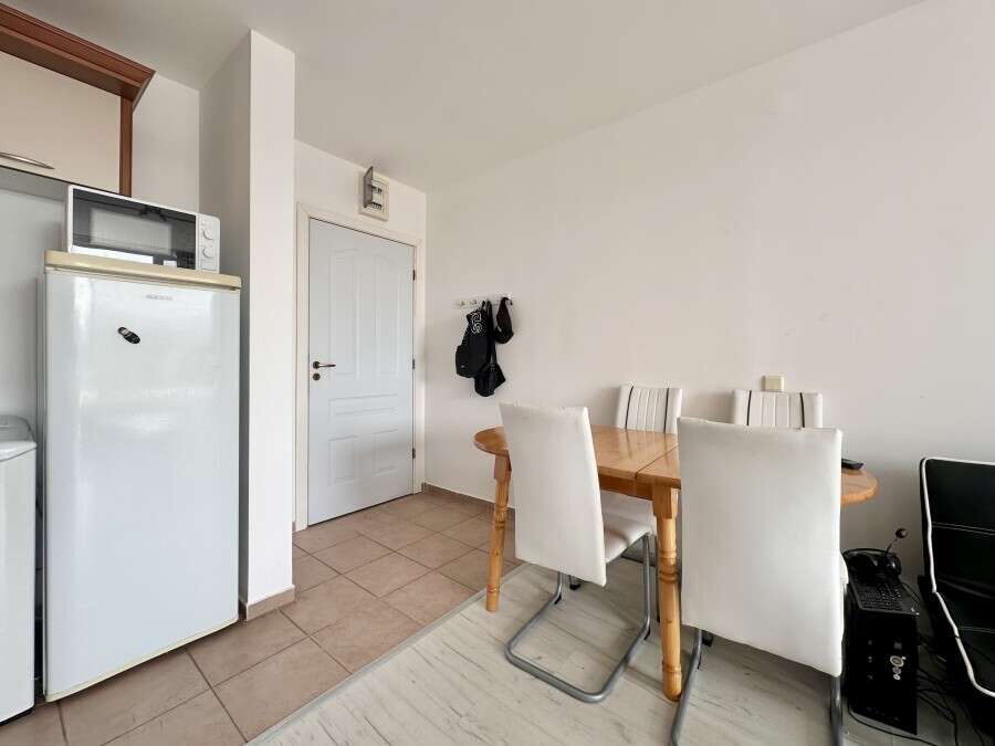 Interior view of a 1-bedroom apartment in Nessebar Fort Club, Sunny Beach, with dining area and basi.