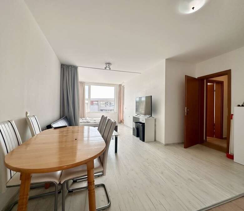 Bright living room with dining area and large window in Nessebar Fort club, Sunny Beach.
