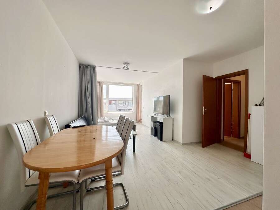 Bright living room with dining area and large window in Nessebar Fort club, Sunny Beach.