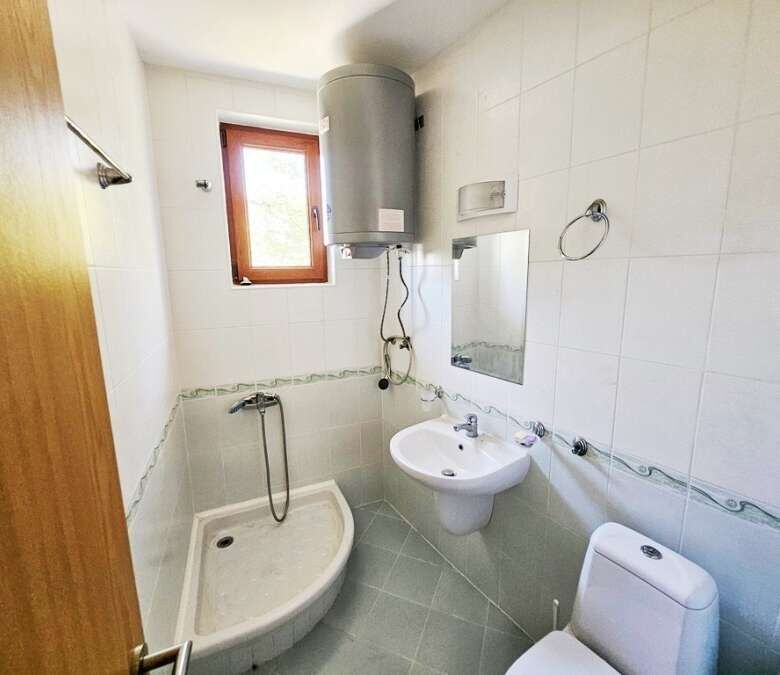 Bright bathroom with shower and water heater in Vineyards SPA Resort.