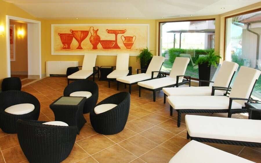 Pool view lounge with sunbeds and seating in Vineyards SPA Resort. Perfect for relaxation and enjoyi.