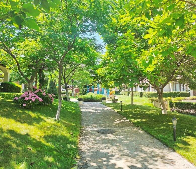 Beautiful garden view with trees and flowers at Vineyards SPA Resort.
