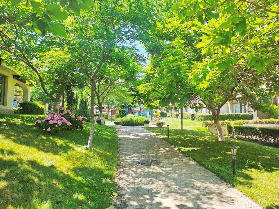 Beautiful garden view with trees and flowers at Vineyards SPA Resort.