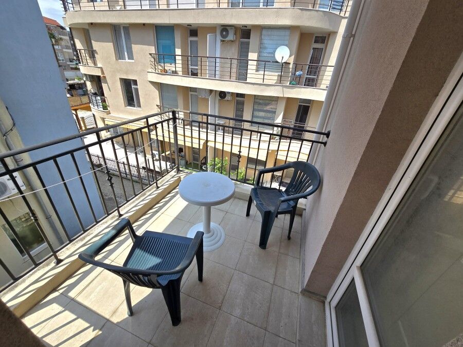 Small balcony with seating in a central Ravda apartment, no maintenance fee.