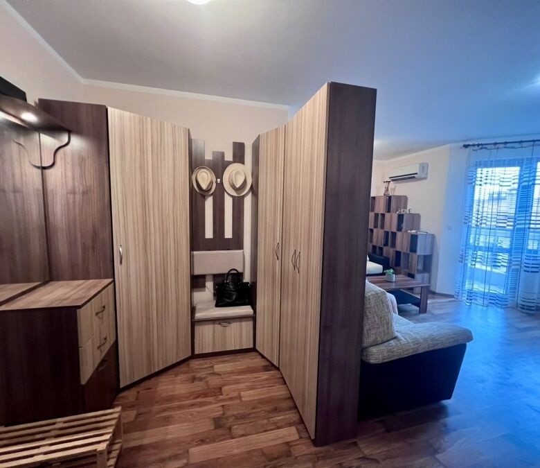 Interior of a spacious studio apartment with pool views in St. Nicola, Kosharitsa.