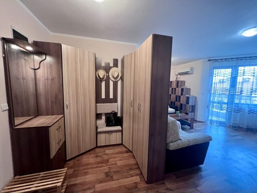 Interior of a spacious studio apartment with pool views in St. Nicola, Kosharitsa.