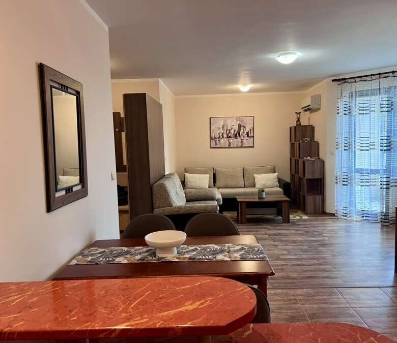 Interior view of a spacious studio apartment with pool views in Kosharitsa, Bulgaria.