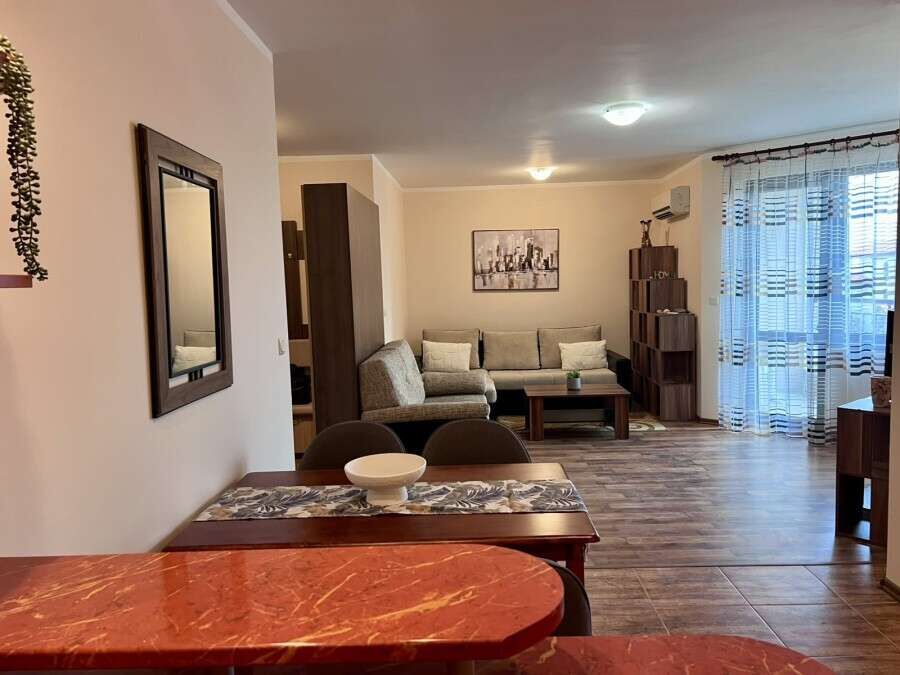 Interior view of a spacious studio apartment with pool views in Kosharitsa, Bulgaria.