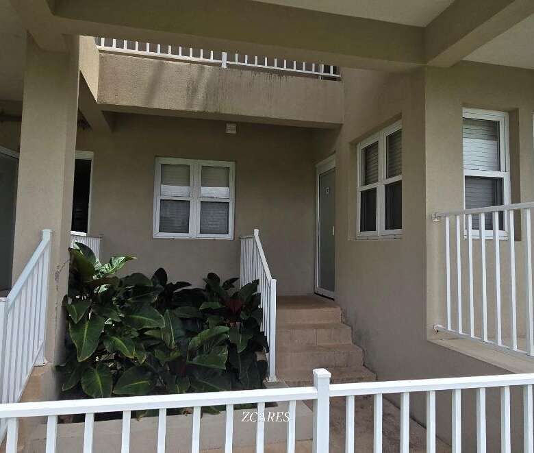 Modern 1-bedroom villa for sale at Imperial Bay Residences, featuring a spacious balcony and lush su.