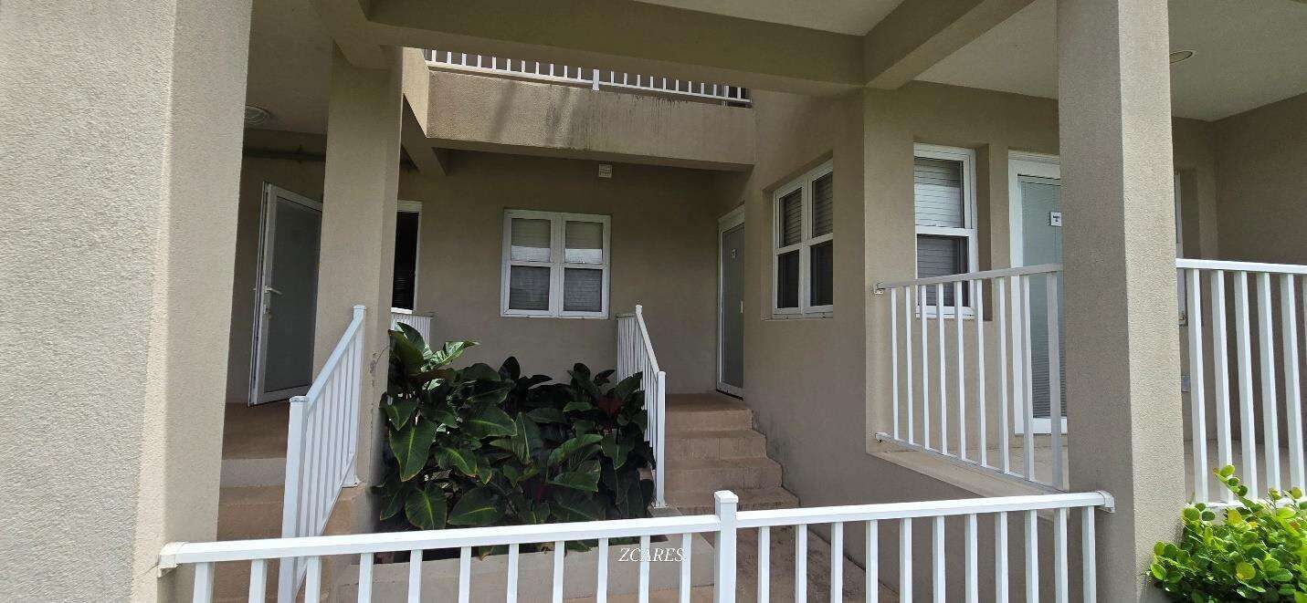 Modern 1-bedroom villa for sale at Imperial Bay Residences, featuring a spacious balcony and lush su.