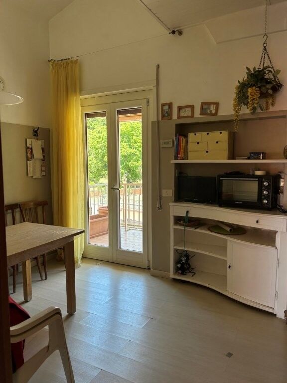Bright living room with access to balcony in Ariccia Rome.