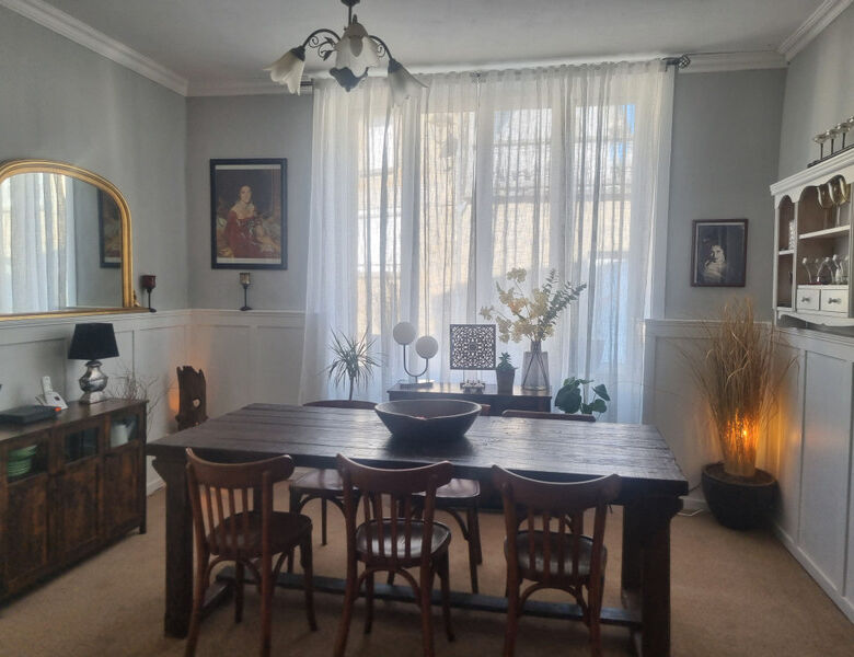 Elegant dining room in a stone mansion with classic decor and natural light. Perfect for luxurious l.