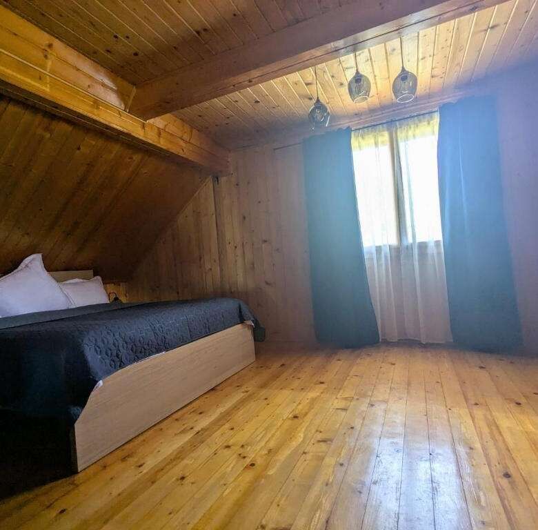 Spacious bedroom in a charming wooden house in Chiriteni, ideal for comfortable living or vacation r.