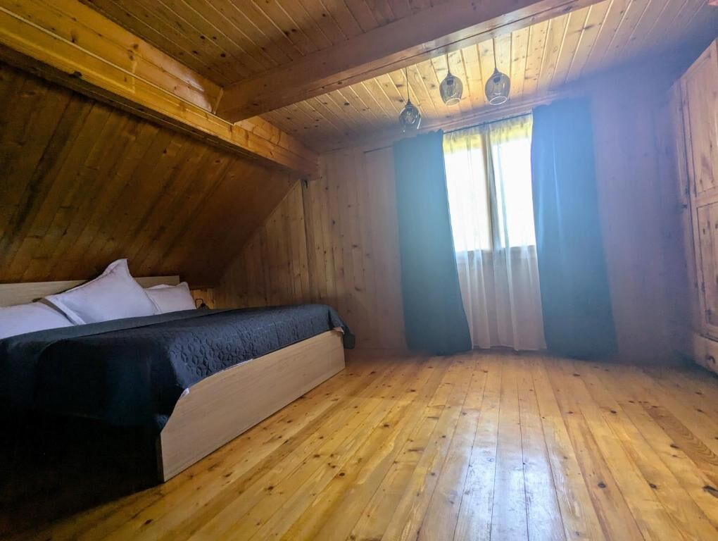 Spacious bedroom in a charming wooden house in Chiriteni, ideal for comfortable living or vacation r.