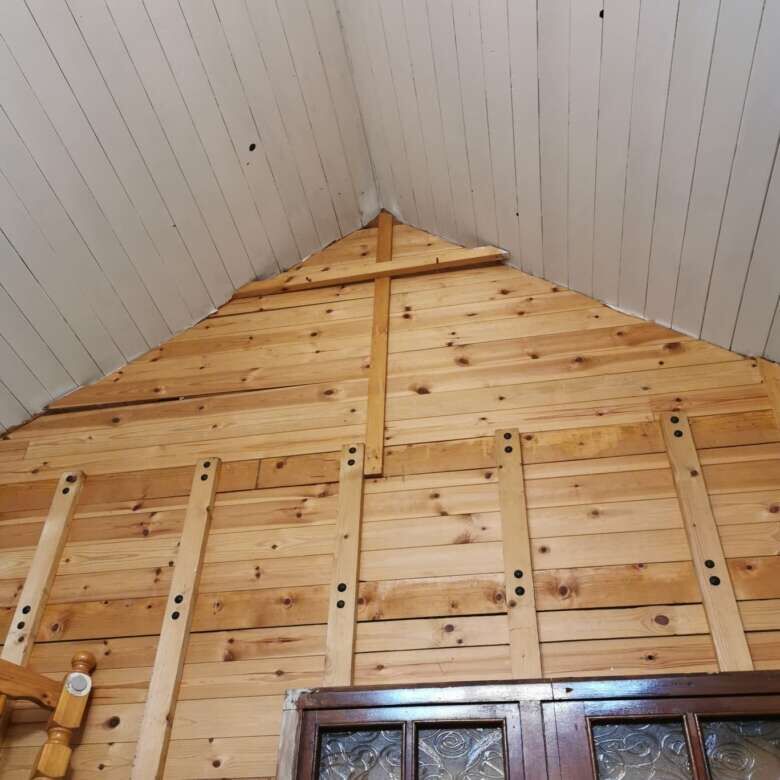 Attic interior with wooden beams and paneling in Cloonagh, County Sligo.