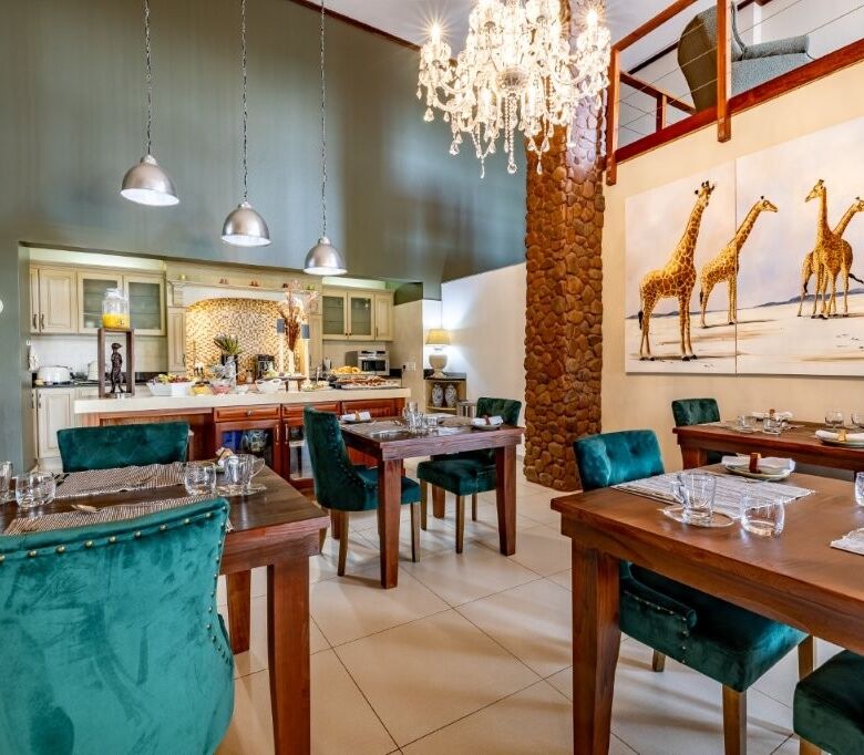Elegant dining area in a luxury estate with stylish decor and spacious seating.