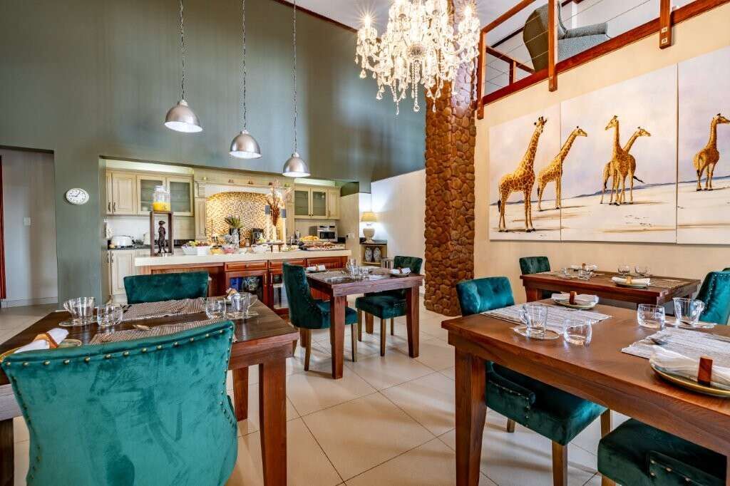 Elegant dining area in a luxury estate with stylish decor and spacious seating.