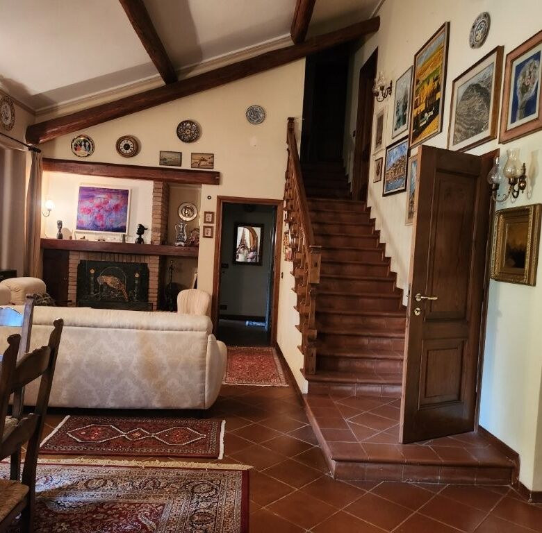 Spacious country villa with elegant decor, high ceilings, and traditional wooden staircase in Salsom.