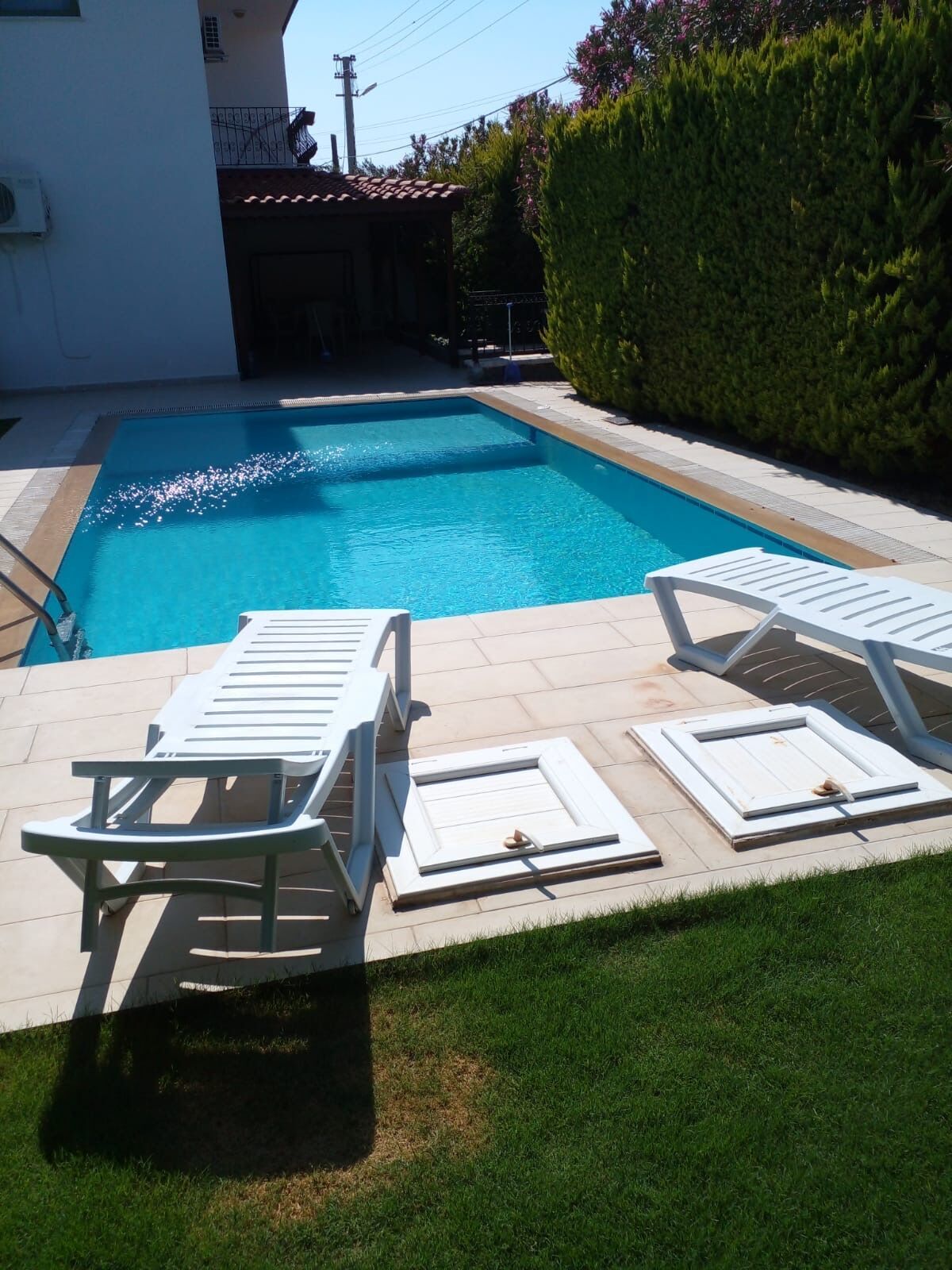 Luxury 3 Bed Villa in Cesme with Pool Pool area of a luxury 3-bedroom villa in Cesme, featuring a private swimming pool and sun loungers.