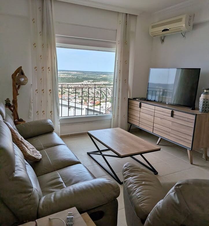 Sea view living room with comfortable sofas and TV in Pearl Rock Retreat, Akbuk Didim. Bright, airy.