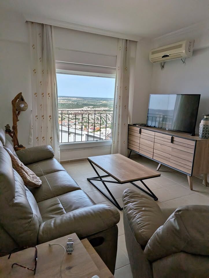 Sea view living room with comfortable sofas and TV in Pearl Rock Retreat, Akbuk Didim. Bright, airy.