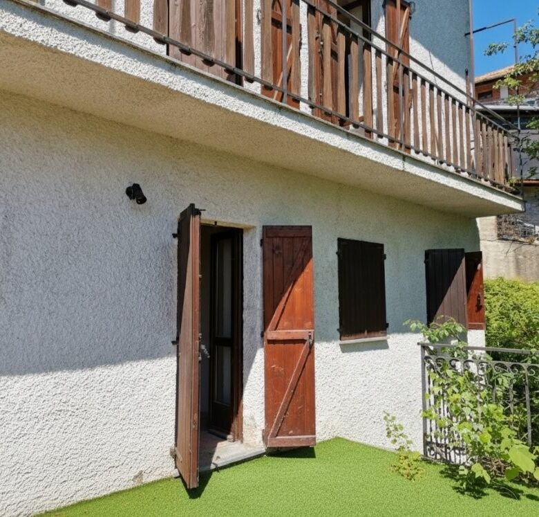 Beautiful exterior view of a two-bedroom villa with wooden shutters and a small garden in Piedmont.