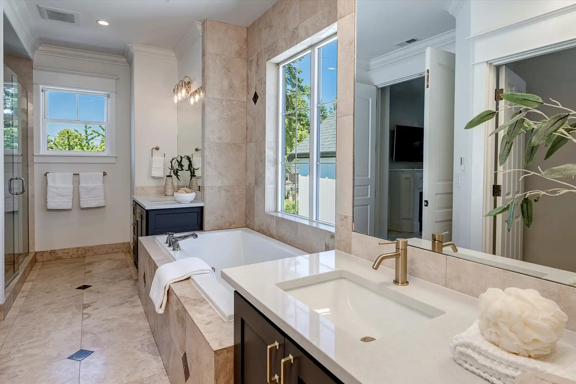 Luxurious lakefront bathroom with modern fixtures and large windows offering scenic views.