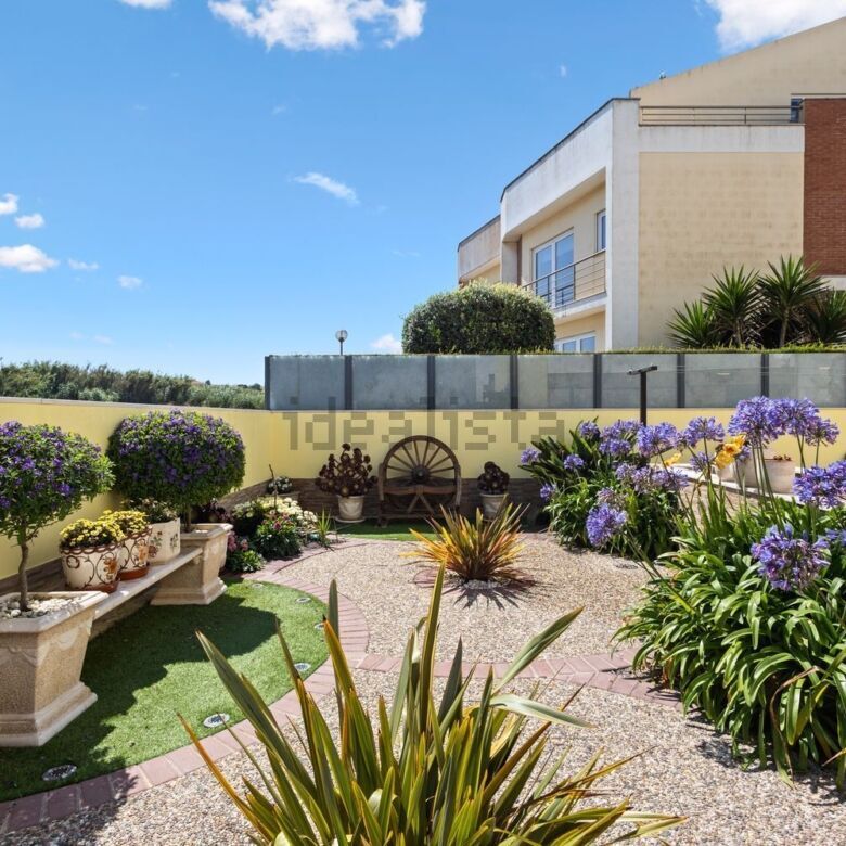 Elegant garden of a luxury 3-bedroom villa in Santa Cruz with vibrant flowers and lush greenery.