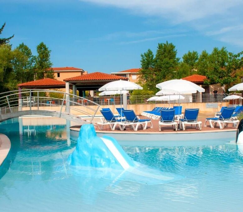 Swimming pool with water slide and sun loungers at a luxury resort in Mandelieu La Napoule.